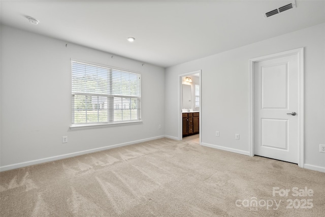 1933 Tin Roof Ln, Monroe, NC 28112 - unfurnished bedroom with baseboards, visible vents, light carpet, and ensuite bathroom