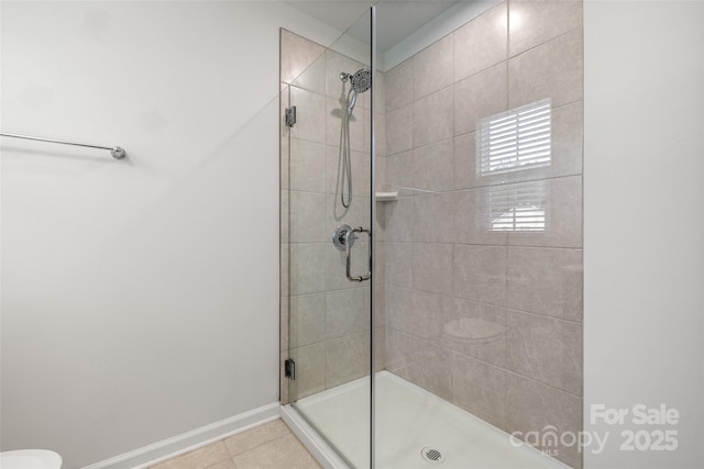 1933 Tin Roof Ln, Monroe, NC 28112 - bathroom featuring tile patterned floors, a tile shower, and baseboards