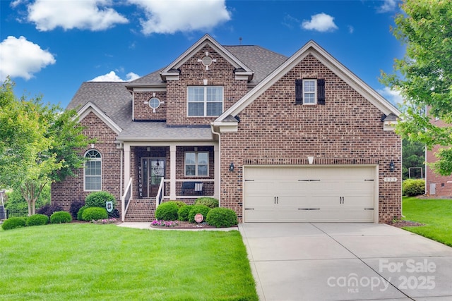 525 Chase Prairie Ln, Waxhaw, NC 28173 - traditional-style home with brick siding, a front yard, driveway, a shingled roof, and a garage
