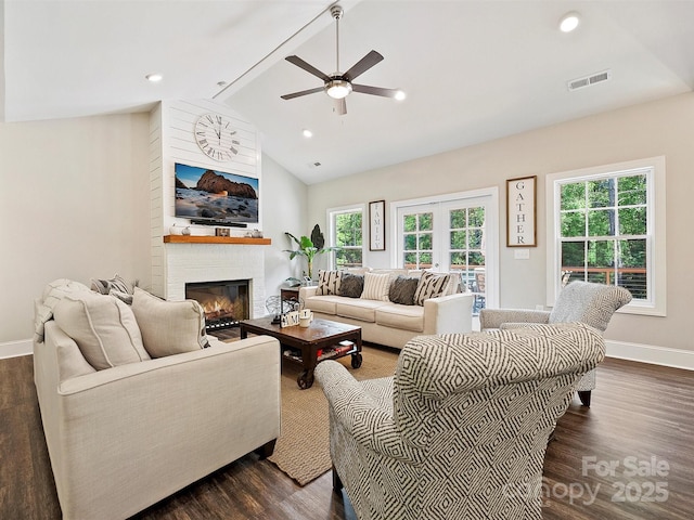living room with a fireplace, visible vents, a ceiling fan, and baseboards