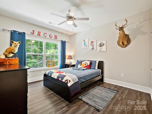 bedroom with visible vents, baseboards, wood finished floors, and ceiling fan