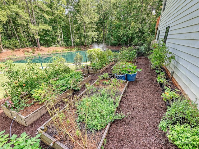 view of yard featuring a vegetable garden and fence