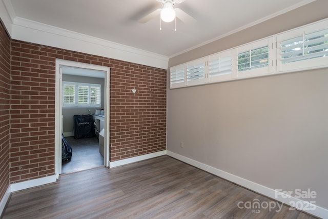 4920 Raymond Pl, Charlotte, NC 28205 - unfurnished room featuring wood finished floors, a ceiling fan, baseboards, crown molding, and brick wall