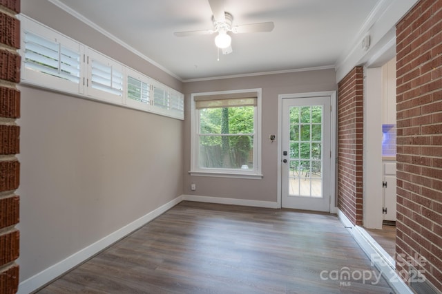 4920 Raymond Pl, Charlotte, NC 28205 - doorway with wood finished floors, a ceiling fan, baseboards, crown molding, and brick wall
