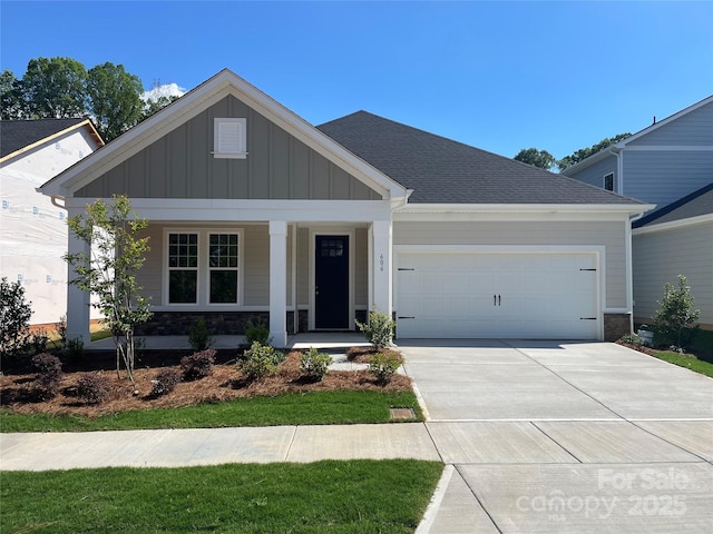 606 Banter Ln Unit 30, Cramerton, NC 28032 - craftsman-style home featuring board and batten siding, a garage, driveway, a porch, and stone siding