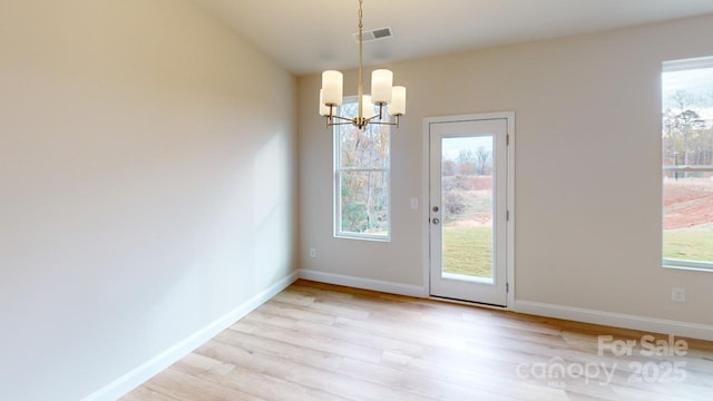 606 Banter Ln Unit 30, Cramerton, NC 28032 - unfurnished dining area with light wood-style flooring, a chandelier, and healthy amount of natural light