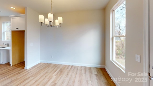 606 Banter Ln Unit 30, Cramerton, NC 28032 - unfurnished dining area with a chandelier, light wood-style flooring, and healthy amount of natural light