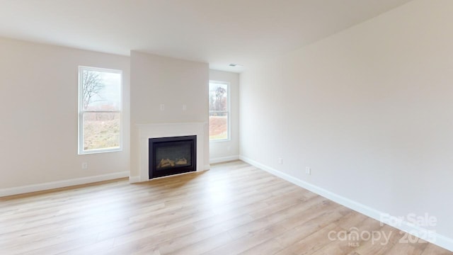 606 Banter Ln Unit 30, Cramerton, NC 28032 - unfurnished living room with light wood finished floors and a glass covered fireplace