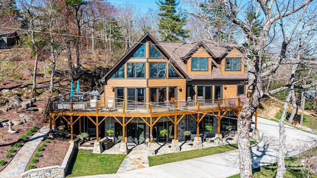 back of property featuring a wooden deck and a patio area
