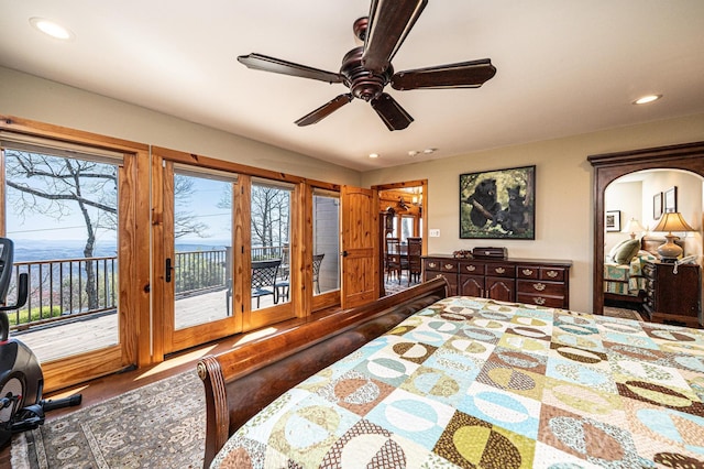bedroom featuring access to outside, wood finished floors, multiple windows, and recessed lighting