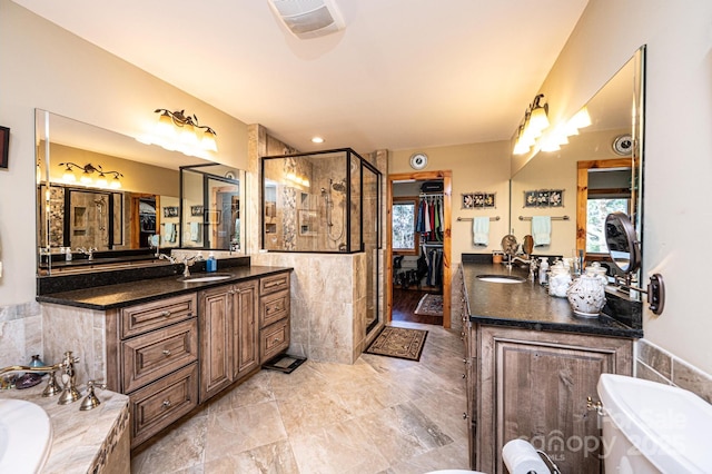 bathroom with a wealth of natural light, a sink, a shower stall, and a bathtub