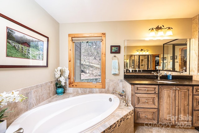 full bathroom with a garden tub and vanity