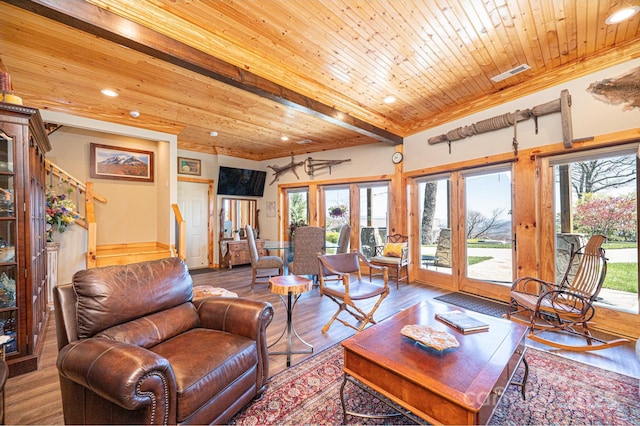 living room featuring recessed lighting, wood finished floors, and visible vents