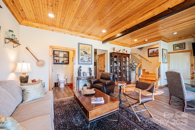 living area with stairway, ornamental molding, wooden ceiling, and wood finished floors