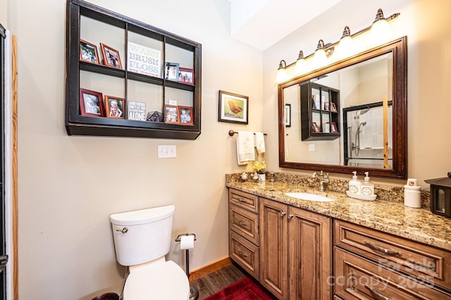 full bath featuring wood finished floors, vanity, and toilet