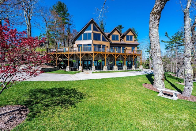 rear view of property with a wooden deck and a yard