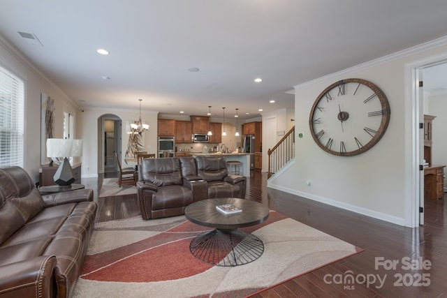 living area featuring arched walkways, baseboards, an inviting chandelier, crown molding, and dark wood-type flooring