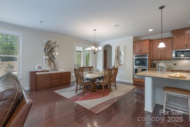 kitchen featuring dark wood finished floors, a healthy amount of sunlight, appliances with stainless steel finishes, and baseboards