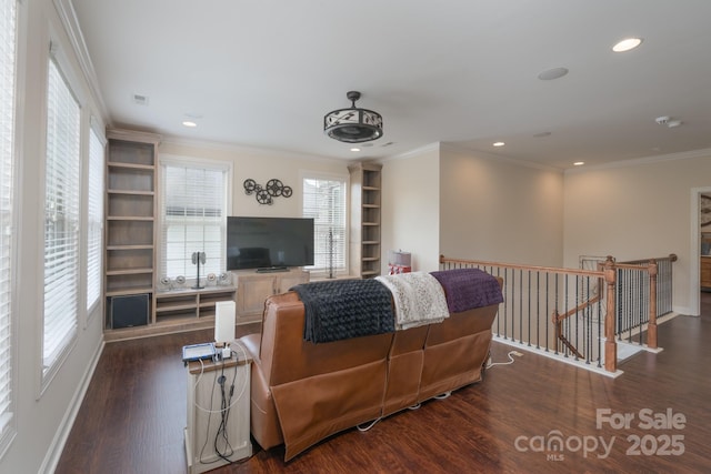 living area with wood finished floors, recessed lighting, built in features, and ornamental molding