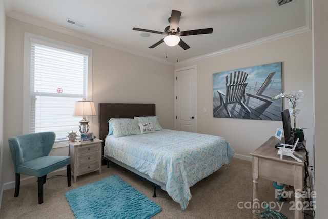 carpeted bedroom featuring ceiling fan, baseboards, ornamental molding, and visible vents