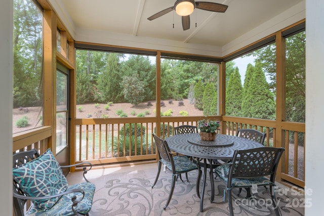 sunroom / solarium featuring ceiling fan and outdoor dining space