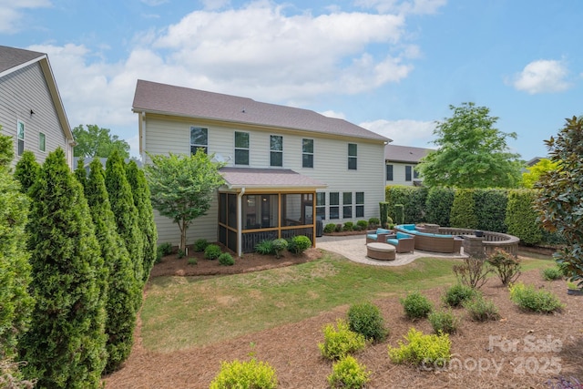 back of property featuring an outdoor living space, a shingled roof, a yard, a patio, and a sunroom