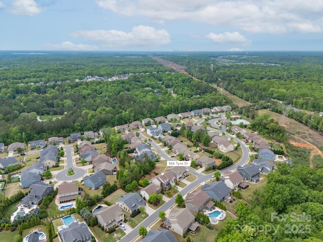 bird's eye view featuring a view of trees and a residential view