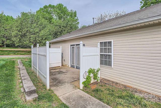 view of home's exterior featuring a patio and fence