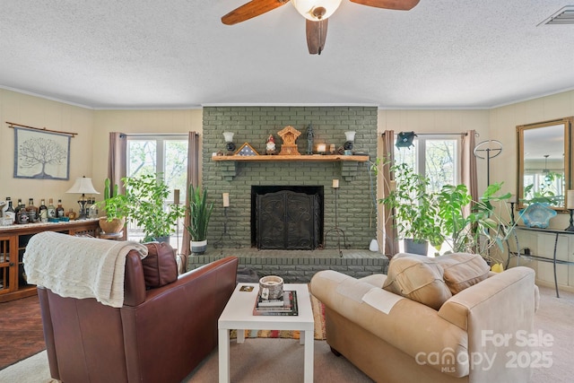 3190 Holly Rd, Connelly Springs, NC 28612 - carpeted living room with ornamental molding, a textured ceiling, a brick fireplace, and ceiling fan