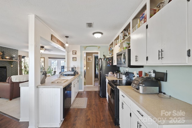 3190 Holly Rd, Connelly Springs, NC 28612 - kitchen with black appliances, dark wood-type flooring, light countertops, white cabinets, and a textured ceiling