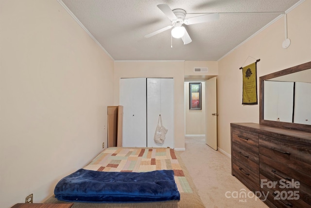 3190 Holly Rd, Connelly Springs, NC 28612 - bedroom with ornamental molding, light colored carpet, a textured ceiling, a closet, and a ceiling fan