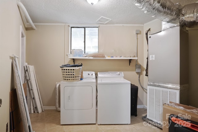 3190 Holly Rd, Connelly Springs, NC 28612 - washroom with a textured ceiling, light tile patterned floors, washing machine and dryer, and heating unit