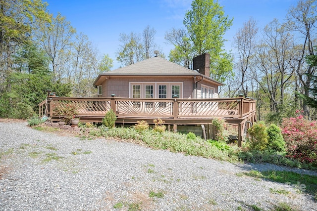 3190 Holly Rd, Connelly Springs, NC 28612 - back of house featuring a wooden deck, a chimney, and a shingled roof