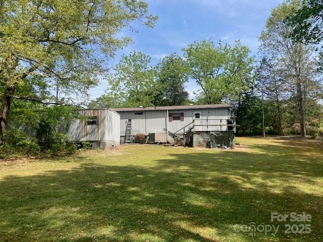 314 Phillips Dr, Forest City, NC 28043 - rear view of house featuring a lawn
