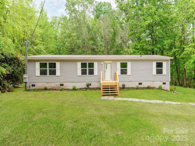 manufactured / mobile home with crawl space and a front lawn