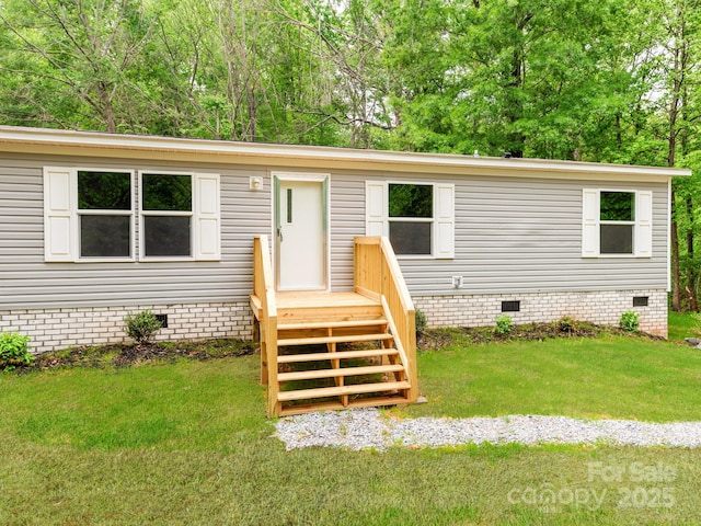 manufactured / mobile home with crawl space and a front yard