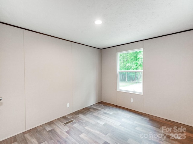 empty room with recessed lighting and light wood finished floors
