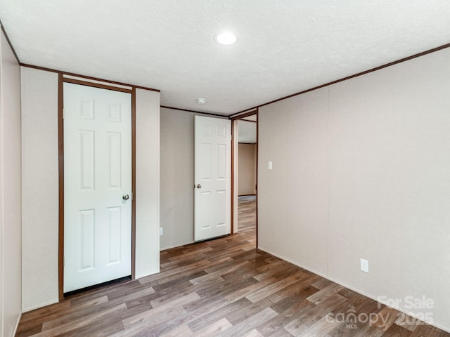 unfurnished bedroom with wood finished floors and recessed lighting