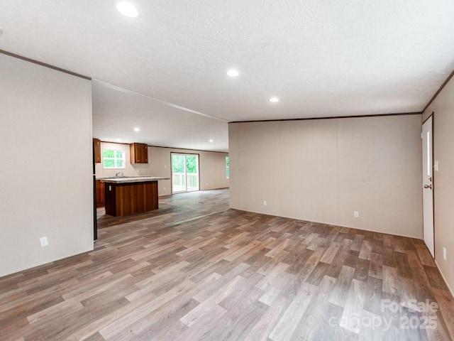 unfurnished living room with recessed lighting and light wood-style floors