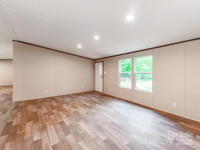 empty room featuring recessed lighting and light wood-style floors