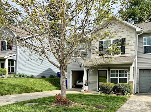 view of front of house featuring a garage, a front lawn, and concrete driveway