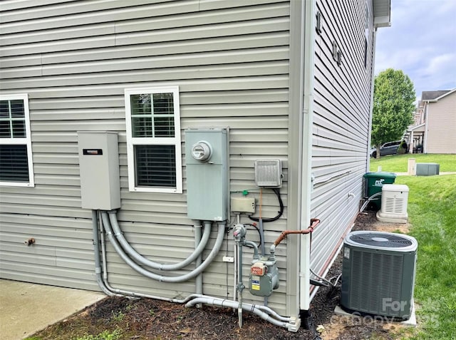 exterior details with electric meter and central AC unit