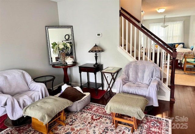 living area featuring hardwood / wood-style floors and stairs
