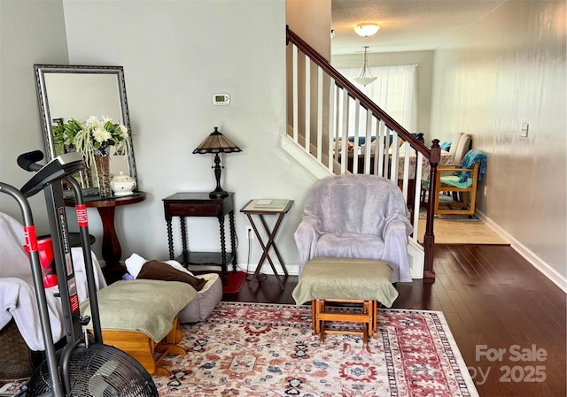 sitting room featuring wood-type flooring and baseboards