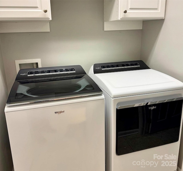 laundry area with cabinet space and separate washer and dryer