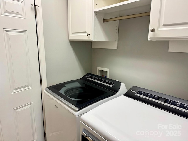 laundry area featuring washing machine and dryer and cabinet space