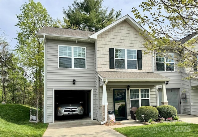 view of front of home featuring a garage, a shingled roof, and concrete driveway