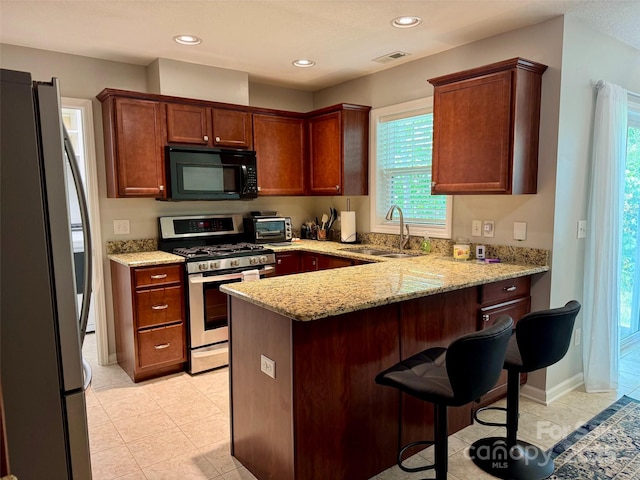 57 Sunny Meadows Blvd, Arden, NC 28704 - kitchen with light stone counters, visible vents, a sink, a peninsula, and stainless steel appliances