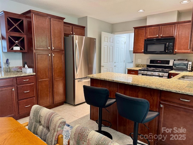 57 Sunny Meadows Blvd, Arden, NC 28704 - kitchen featuring a toaster, recessed lighting, a breakfast bar, light stone counters, and appliances with stainless steel finishes