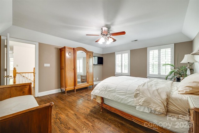 bedroom featuring visible vents, baseboards, ceiling fan, and dark wood-style floors